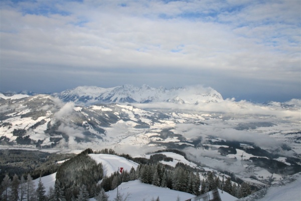 View over the snow-covered Austrian Alps from the top of a mountain in the ski resort of Kitzbühel